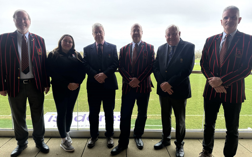 Rugby officials pose in front of pitch