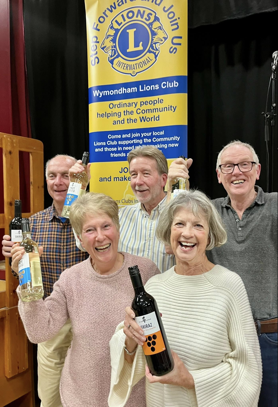 Group of people holding bottles and cheering