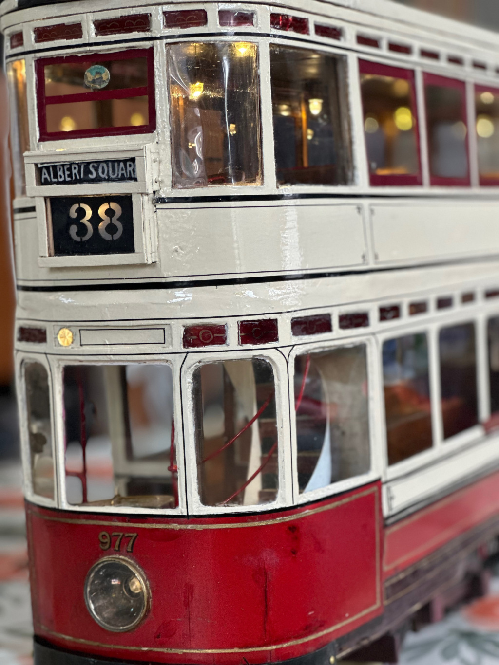 Close up of model tram painted red and white