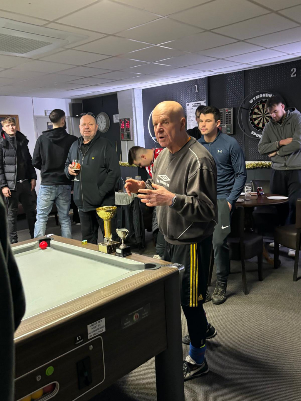People crowding round a pool table