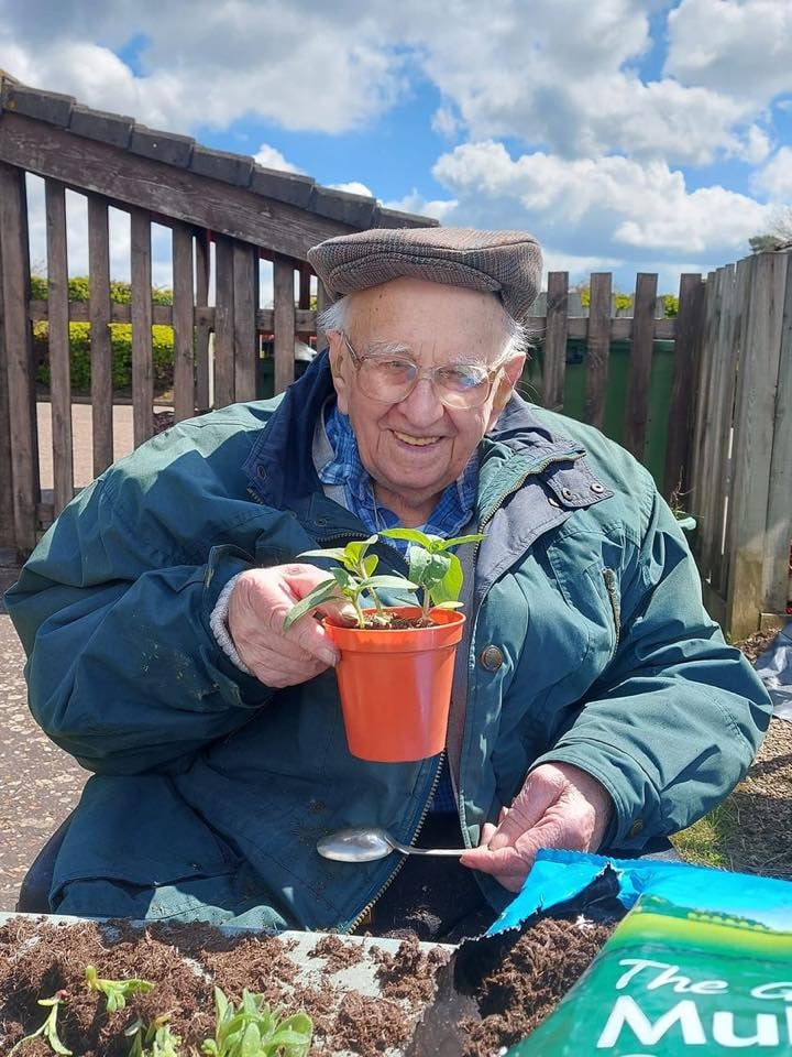 Owen James planting a sunflower