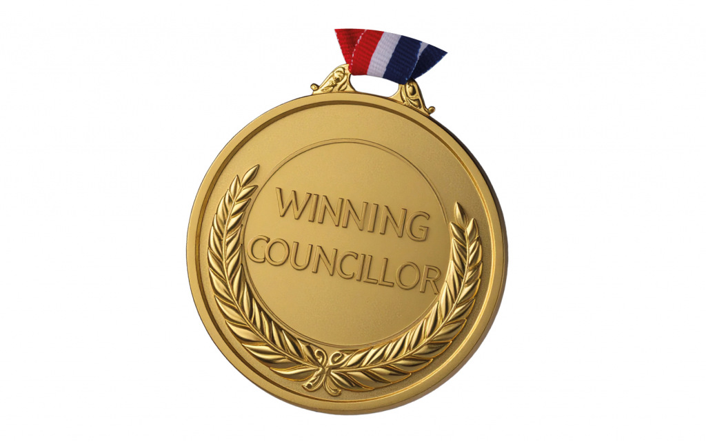 A medal saying winning councillor