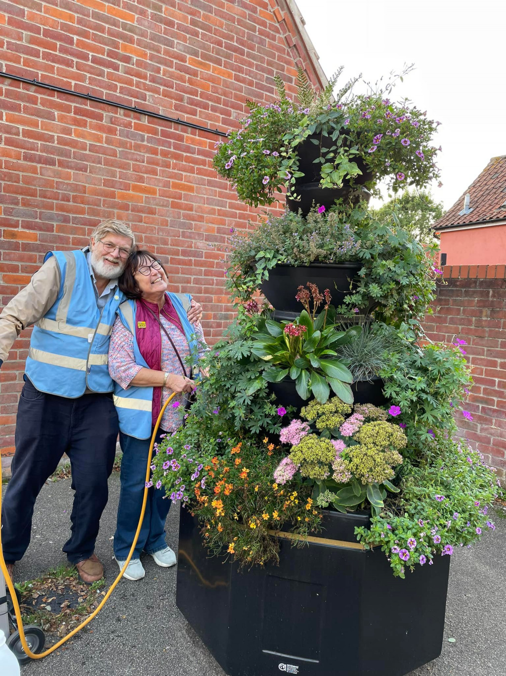 Janet and Keith Benjafield standing with a plant