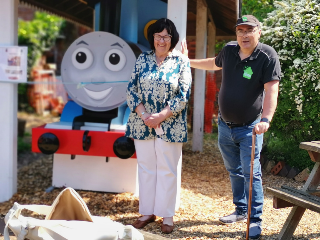 Janet Benjafield and Andrew Clarke standing with Thomas the Tank Engine