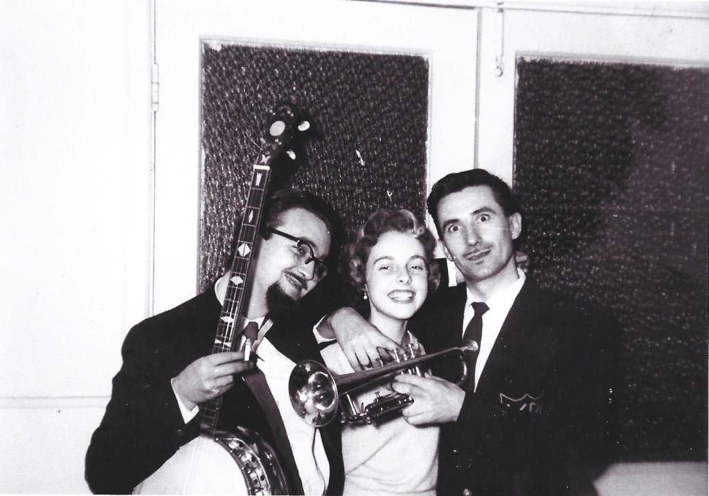Two men and a woman with musical instruments