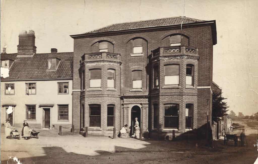 Old picture of large brick townhouse