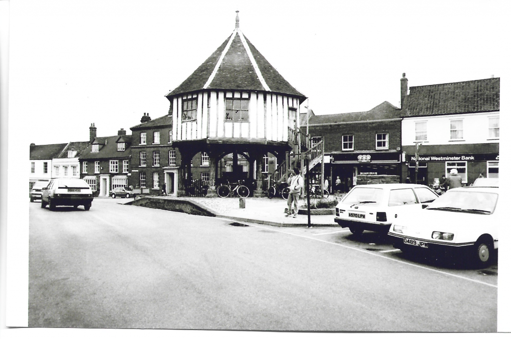 Old photo from 70s with market cross and cars