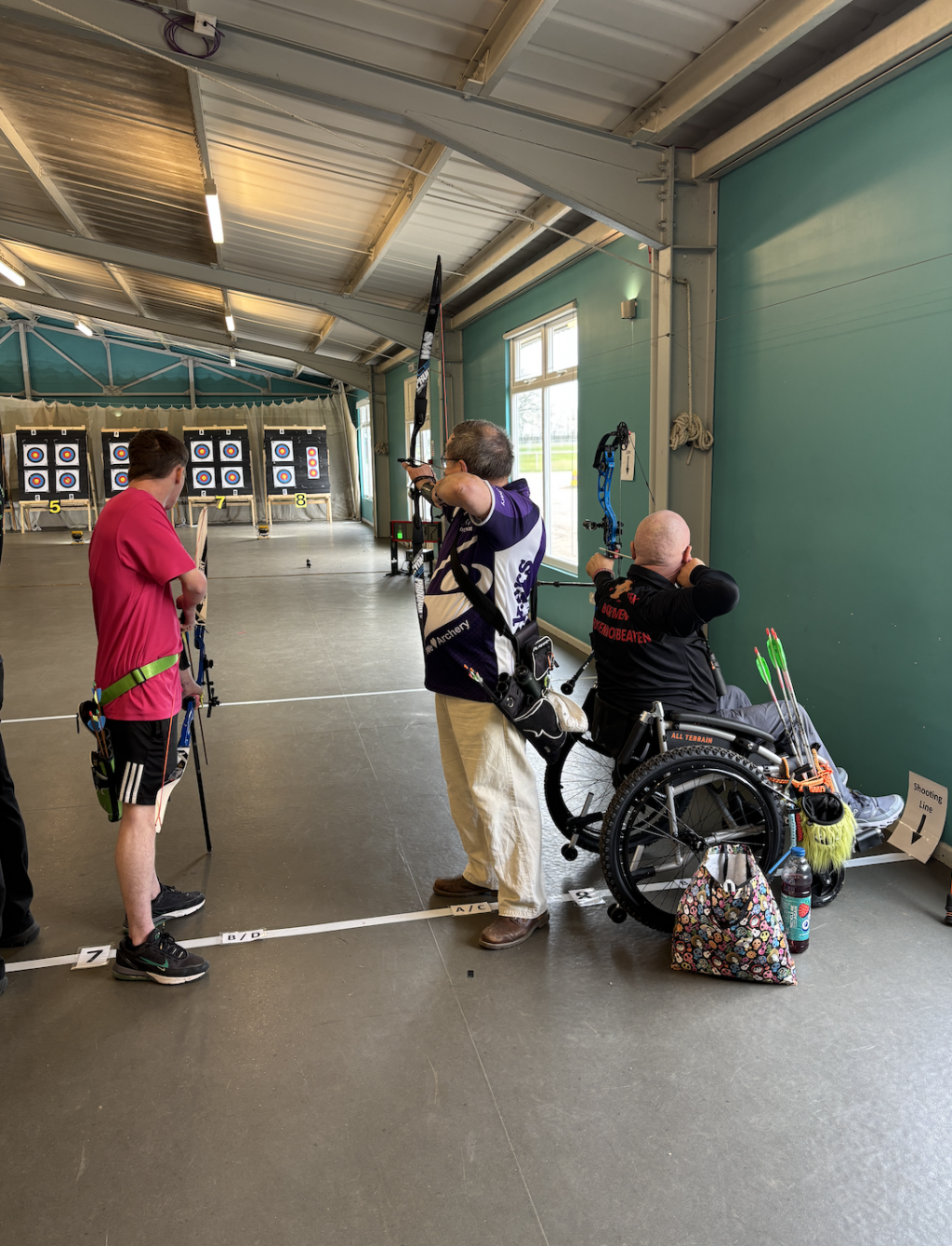 Three men doing archery