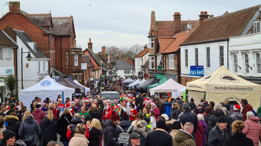 People gathered in Christmas outfits outside