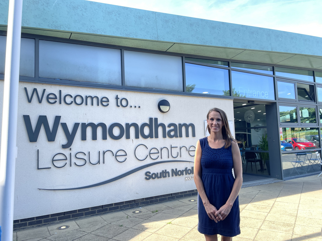 woman in navy dress in front of leisure centre