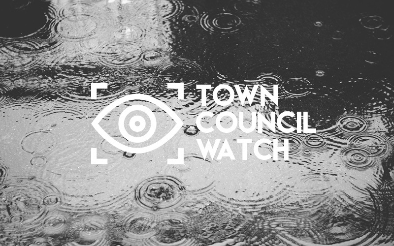 Rainy puddle and Town Council Watch lettering